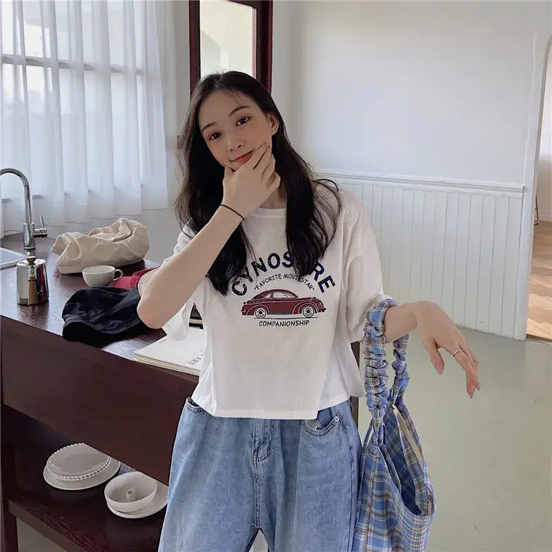 Short Sleeve T-Shirt for Women showcased by a model in a bright indoor setting, embracing a stylish casual look.