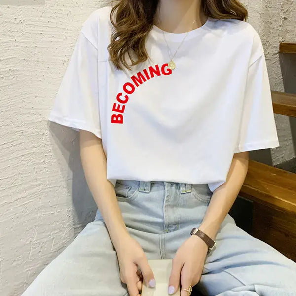 Woman wearing a Pure Cotton Short Sleeve T-Shirt for Women with the word 'BECOMING' printed in red.