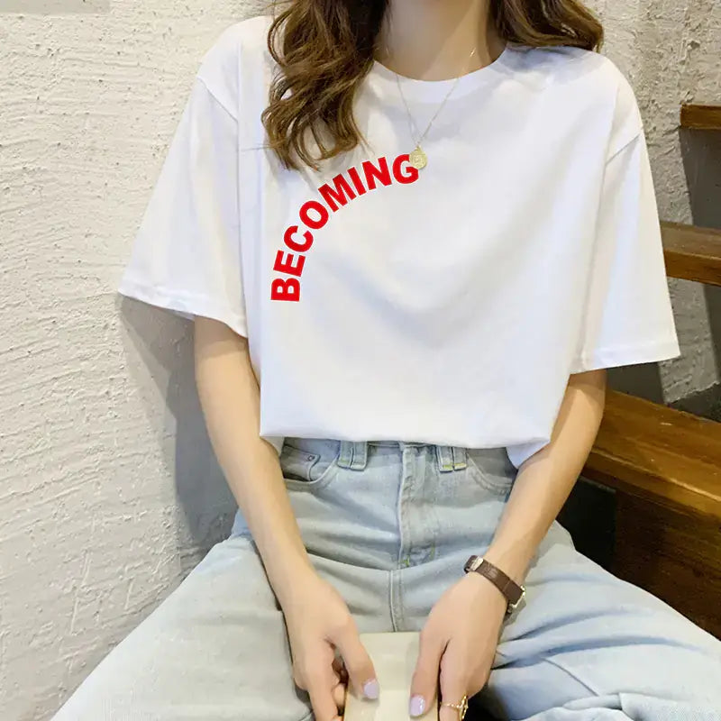 Woman wearing a Pure Cotton Short Sleeve T-Shirt for Women with the word 'BECOMING' printed in red.