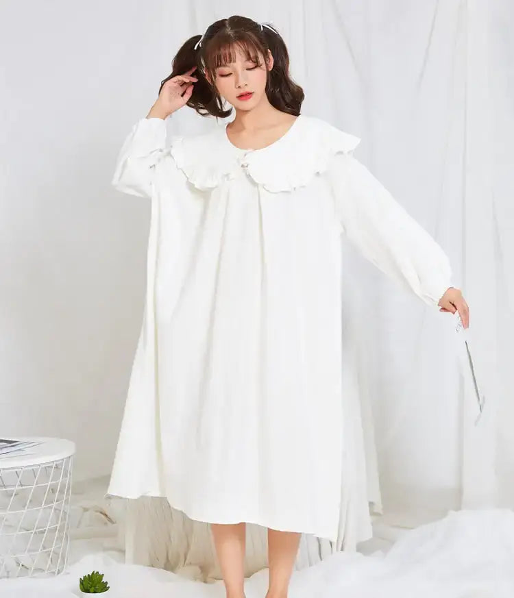Pajamas and Home Wear for Pregnant Women, featuring a cozy long-sleeved white dress with ruffle neckline.