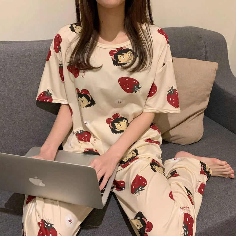 Fashion Cartoon Pajamas for Women worn by a woman sitting on a couch with a laptop.