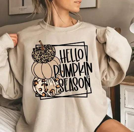 October Magic Women's Cotton Sweater with pumpkin season design in a cozy fall setting.