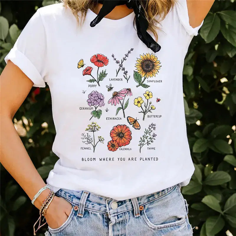 Women's Short Sleeve T-Shirt featuring a floral print design with vibrant flowers and the phrase 'BLOOM WHERE YOU ARE PLANTED'