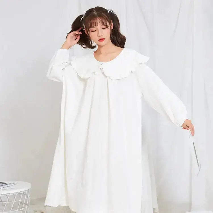 Pajamas and Home Wear for Pregnant Women in a stylish long-sleeved white dress with ruffle details.