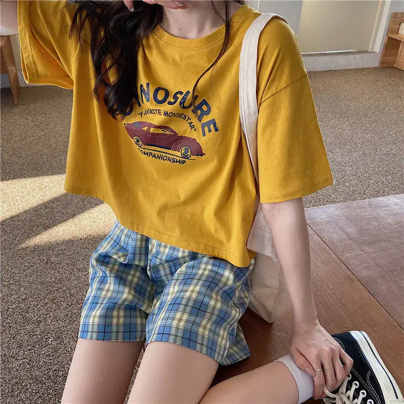 Short Sleeve T-Shirt for Women in yellow with graphic design, paired with plaid shorts, captures summer style.