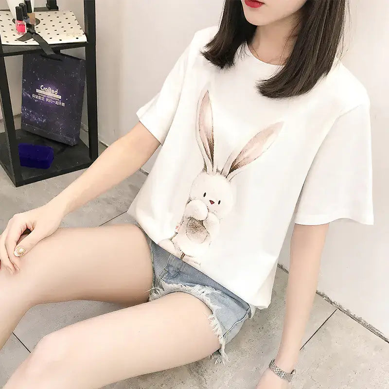 Woman wearing a loose-fitting Short Sleeve T-Shirt for Women with a playful bunny design, perfect for summer.