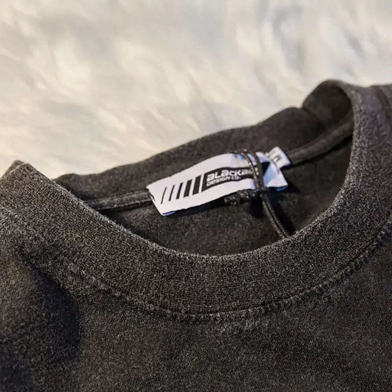 Vintage Street Style Loose Graphic T-Shirt close-up of collar and tag details on soft fabric.