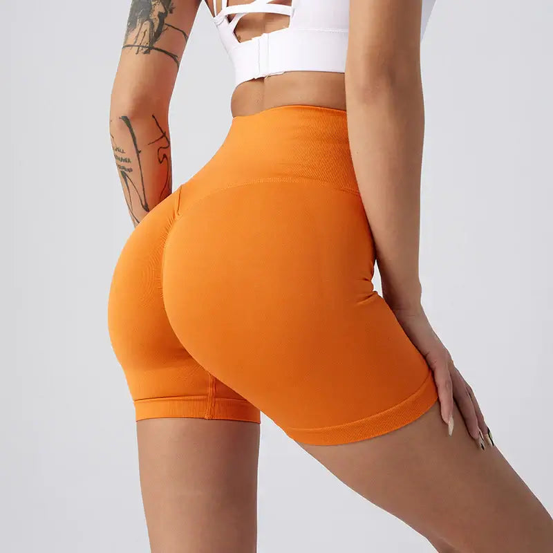 Women Yoga Shorts in orange, featuring a stylish fit and breathable fabric for ultimate comfort during workouts.