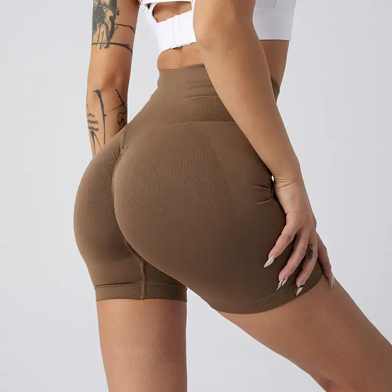 Women Yoga Shorts in brown fabric, designed for comfort and style during workouts.