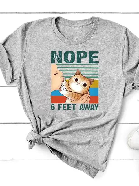 Short Sleeve T-Shirt for Women featuring a playful cat graphic and the text 'NOPE 6 FEET AWAY' in vibrant colors.